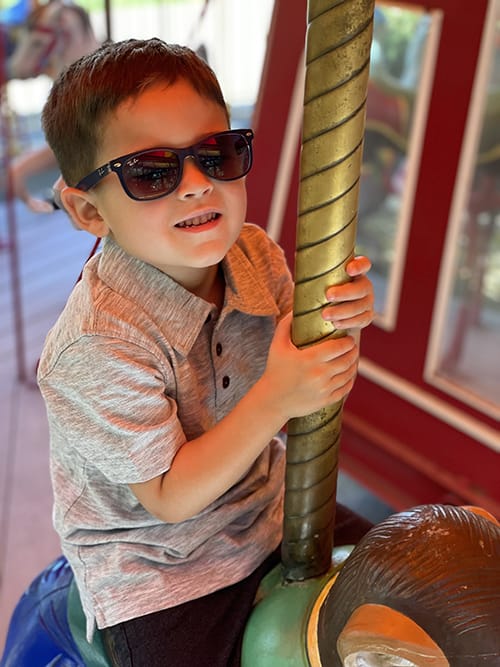 Photo of a child wearing sunglasses.